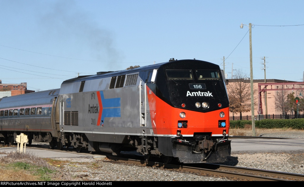 AMTK 156 leads train P080 away from the station